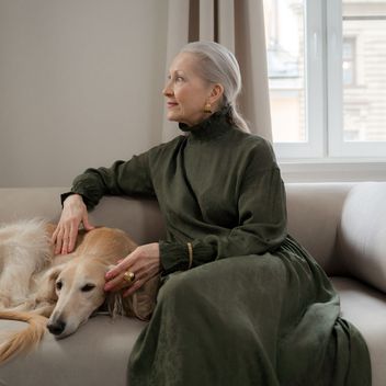 A person holding a senior dog closely